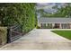This single-story home has a long driveway, mature landscaping, and a secure entry gate at 3906 Floyd Rd, Tampa, FL 33618