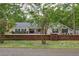 Charming single-story home with mature trees and landscaping with a brick fence at 3906 Floyd Rd, Tampa, FL 33618