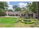 Inviting home with a well-manicured lawn and mature trees adding to the curb appeal at 3906 Floyd Rd, Tampa, FL 33618