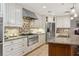 Well-appointed kitchen featuring granite countertops, stainless steel appliances, and custom cabinetry at 3906 Floyd Rd, Tampa, FL 33618