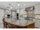 Gourmet kitchen with granite countertops, stainless steel appliances, and a large island with seating at 3906 Floyd Rd, Tampa, FL 33618