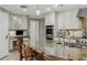 Kitchen with granite countertops, stainless steel appliances, a large island and desk at 3906 Floyd Rd, Tampa, FL 33618