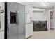Laundry room featuring stainless steel fridge and gray washer and dryer at 3906 Floyd Rd, Tampa, FL 33618