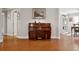 Cozy living room featuring a grand piano and warm hardwood floors at 3906 Floyd Rd, Tampa, FL 33618