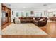 Expansive living room with hardwood floors, a comfortable leather sectional, and natural light at 3906 Floyd Rd, Tampa, FL 33618