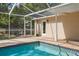 View of the refreshing screened-in pool and patio area perfect for relaxation and outdoor enjoyment at 3906 Floyd Rd, Tampa, FL 33618