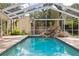 The screened-in pool has an integrated rock structure for an enhanced swimming experience at 3906 Floyd Rd, Tampa, FL 33618