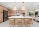 Modern kitchen features stainless steel appliances, custom cabinetry, and a large center island with bar seating at 3923 Corsica Pl, Wesley Chapel, FL 33543