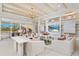 Spacious living room with a custom built in wall unit with shelves and TV, and views of the outdoor patio at 3923 Corsica Pl, Wesley Chapel, FL 33543
