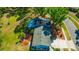 Aerial view of a well maintained single-Gathering home with mature trees and a lush green lawn in a quiet neighborhood at 4012 Woodacre Ln, Tampa, FL 33624