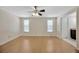 Spacious bedroom with hardwood floors, a ceiling fan, and natural light at 4012 Woodacre Ln, Tampa, FL 33624