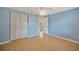 Bedroom with a double closet, ceiling fan and wood flooring at 4012 Woodacre Ln, Tampa, FL 33624
