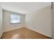 Bedroom with wood floor and window with blinds at 4012 Woodacre Ln, Tampa, FL 33624