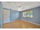 Well-lit bedroom featuring a ceiling fan, wood flooring, and a window with blinds at 4012 Woodacre Ln, Tampa, FL 33624