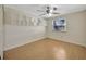 Bedroom with a ceiling fan, built-in shelving and a window letting in natural light at 4012 Woodacre Ln, Tampa, FL 33624