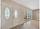 Sunlit entryway with tile floors, decorative doors, and a view into the living room at 4012 Woodacre Ln, Tampa, FL 33624