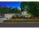Charming home featuring a well-manicured lawn, beautiful landscaping, and a two-car garage at 4012 Woodacre Ln, Tampa, FL 33624