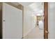 Hallway with neutral color walls, appliances, and tiled flooring at 4012 Woodacre Ln, Tampa, FL 33624