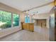 Bright kitchen with breakfast bar and large windows overlooking the backyard at 4012 Woodacre Ln, Tampa, FL 33624