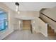View of the staircase, loft, and living room from the kitchen, featuring tile flooring at 4012 Woodacre Ln, Tampa, FL 33624