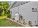 Exterior view of the house with a propane tank and well-maintained landscaping at 4012 Woodacre Ln, Tampa, FL 33624