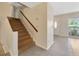 Welcoming foyer with staircase leading to the second level, and a view into the living room at 4012 Woodacre Ln, Tampa, FL 33624