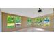 Sun room featuring large windows overlooking lush greenery at 4012 Woodacre Ln, Tampa, FL 33624