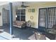 Covered back porch with fan, table, and chairs, perfect for relaxing or entertaining at 4074 Parkway Blvd, Land O Lakes, FL 34639