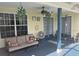 Relaxing back porch with comfortable seating and ceiling fan for outdoor enjoyment at 4074 Parkway Blvd, Land O Lakes, FL 34639