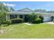 Charming single-story home with well-manicured lawn and mature landscaping at 4074 Parkway Blvd, Land O Lakes, FL 34639