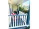 Charming covered porch with red table and chairs, ideal for relaxing outdoors at 4074 Parkway Blvd, Land O Lakes, FL 34639