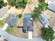 Aerial view of a home with a fenced backyard and screened-in pool in a suburban neighborhood at 4302 Longfellow Dr, Plant City, FL 33566