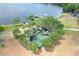 Aerial view of lakeside park featuring a modern playground surrounded by trees at 4302 Longfellow Dr, Plant City, FL 33566