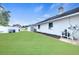 Green backyard with white fencing, manicured mulch beds, and home exterior at 4302 Longfellow Dr, Plant City, FL 33566