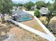 Backyard view featuring a screened-in pool and a white fence surrounding the perimeter of the property at 4302 Longfellow Dr, Plant City, FL 33566