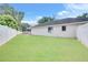 Expansive backyard with healthy lawn space, enclosed by a white fence at 4302 Longfellow Dr, Plant City, FL 33566