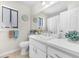 All white bathroom with vanity, decorative accessories, and tiled floor at 4302 Longfellow Dr, Plant City, FL 33566