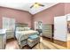 Primary bedroom features wood floors, natural lighting, a ceiling fan, and an ensuite bathroom at 4302 Longfellow Dr, Plant City, FL 33566