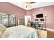 Bedroom with ceiling fan, closet, hardwood floors, and a view of the office space at 4302 Longfellow Dr, Plant City, FL 33566