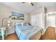 Bedroom boasts a ceiling fan, hardwood floors, and nautical themed decor at 4302 Longfellow Dr, Plant City, FL 33566