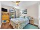 Bedroom with a ceiling fan, decorative painting and hardwood floors at 4302 Longfellow Dr, Plant City, FL 33566