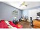 Bedroom with hardwood floors, ceiling fan, guitars and musical themed decor at 4302 Longfellow Dr, Plant City, FL 33566