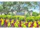 Well-maintained community entrance sign with colorful flowers and manicured greenery at 4302 Longfellow Dr, Plant City, FL 33566