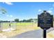 Community dog park featuring a fenced-in area, walking path, and welcoming signage at Walden Lake at 4302 Longfellow Dr, Plant City, FL 33566