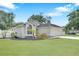 Charming single-story home with well-manicured lawn and garden, a two-car garage, and beautiful arched window at 4302 Longfellow Dr, Plant City, FL 33566
