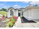 Inviting home with a pathway leading to the front door, complemented by colorful flowers and well-maintained landscaping at 4302 Longfellow Dr, Plant City, FL 33566