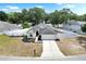 Charming single-Gathering home with manicured landscaping, a long driveway, and a two-car garage at 4302 Longfellow Dr, Plant City, FL 33566