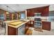 Modern kitchen includes stainless steel appliances, wood cabinets, and a breakfast bar overlooking the dining area at 4302 Longfellow Dr, Plant City, FL 33566