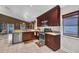 Open kitchen with stainless steel appliances, wooden cabinetry, and a breakfast bar leading to the dining space at 4302 Longfellow Dr, Plant City, FL 33566