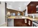 Spacious kitchen featuring dark wood cabinets, stainless steel appliances, and an open view to the dining area at 4302 Longfellow Dr, Plant City, FL 33566
